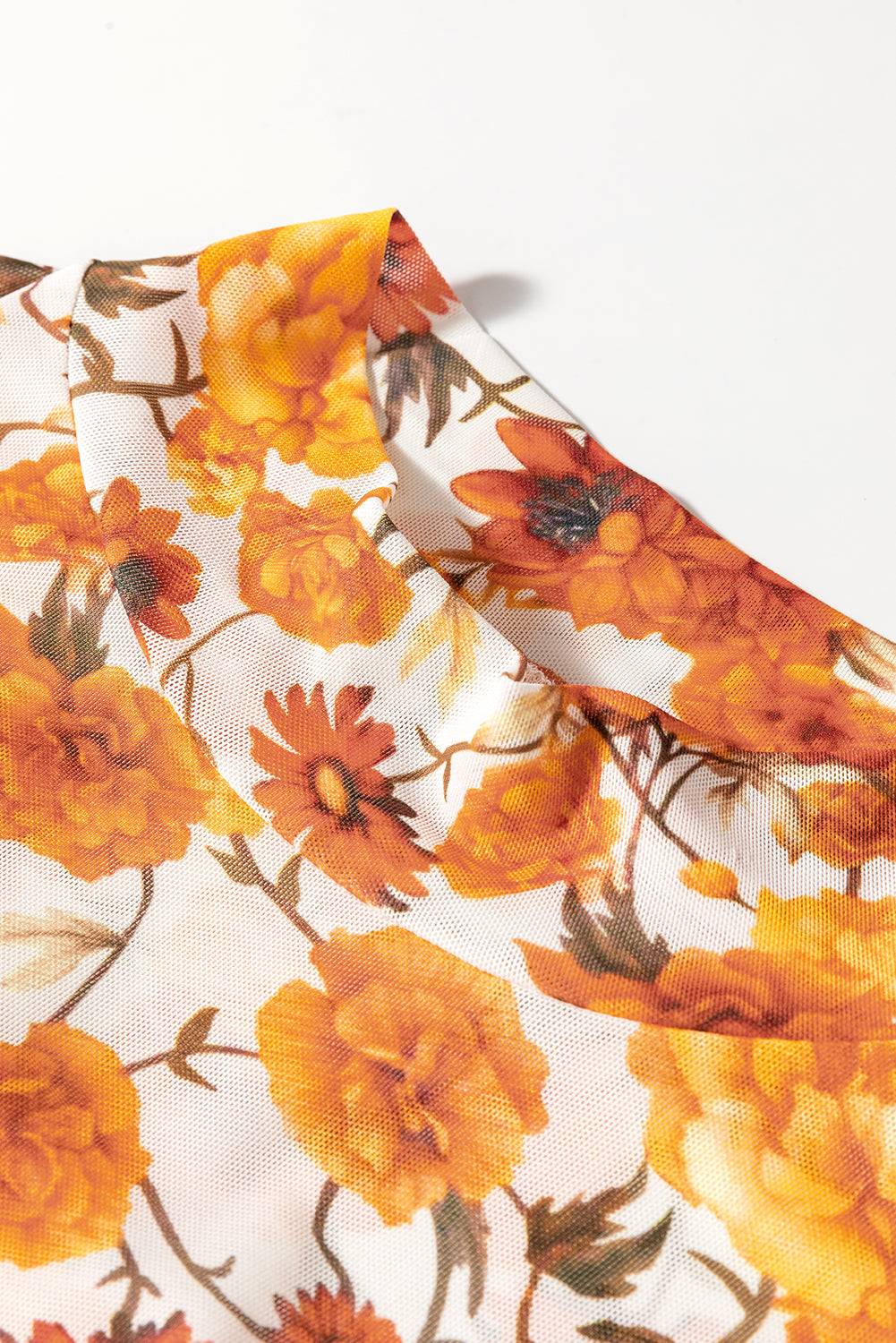 Close-up of floral pattern on mock neck top