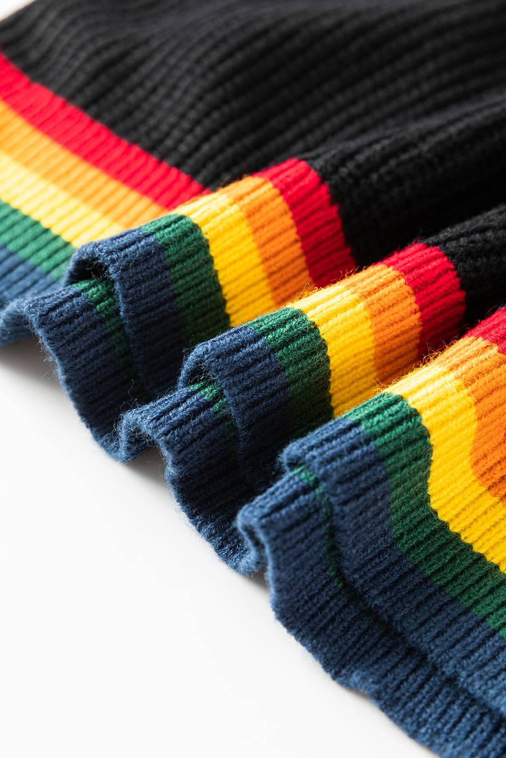 Close-up of black sweater hem with rainbow trim