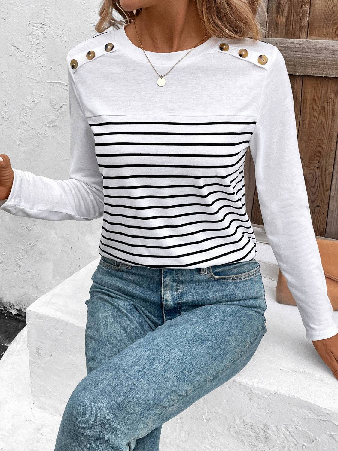 Striped T-shirt with button accents, paired with jeans.