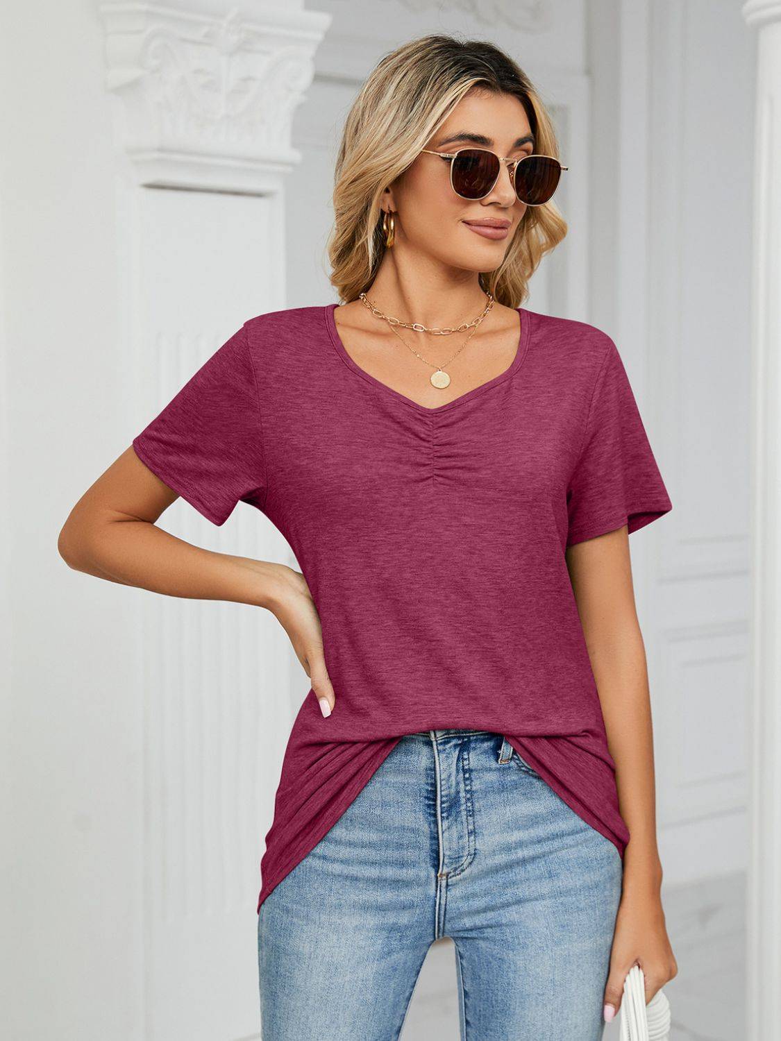 Purple ruched V-neck T-shirt styled with sunglasses