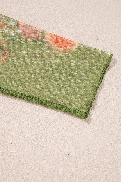 Close-up of floral patchwork sleeve on green top