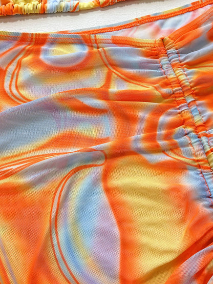 Close-up of ruched fabric on multicolored bikini.