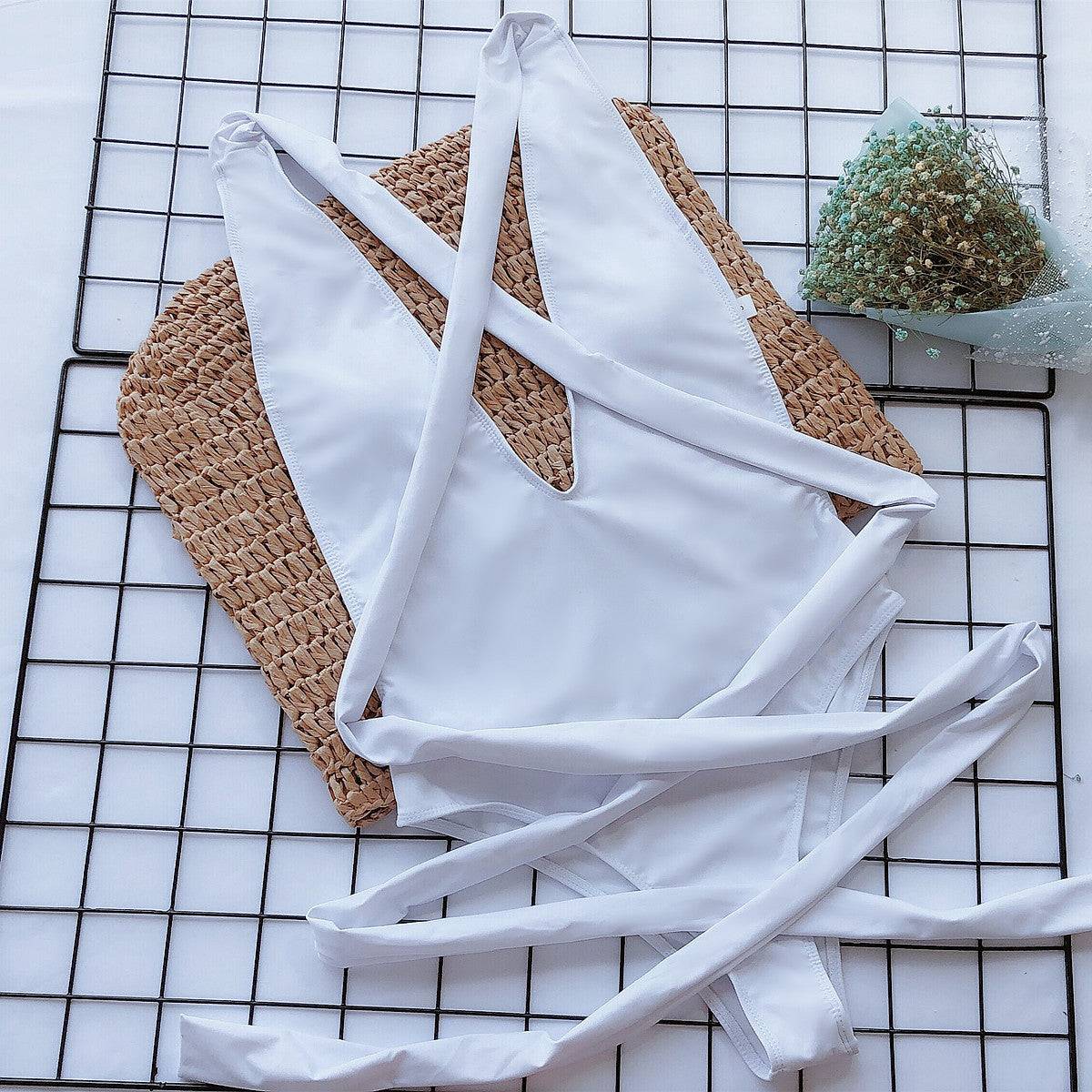 Flat lay of white tied one-piece swimsuit