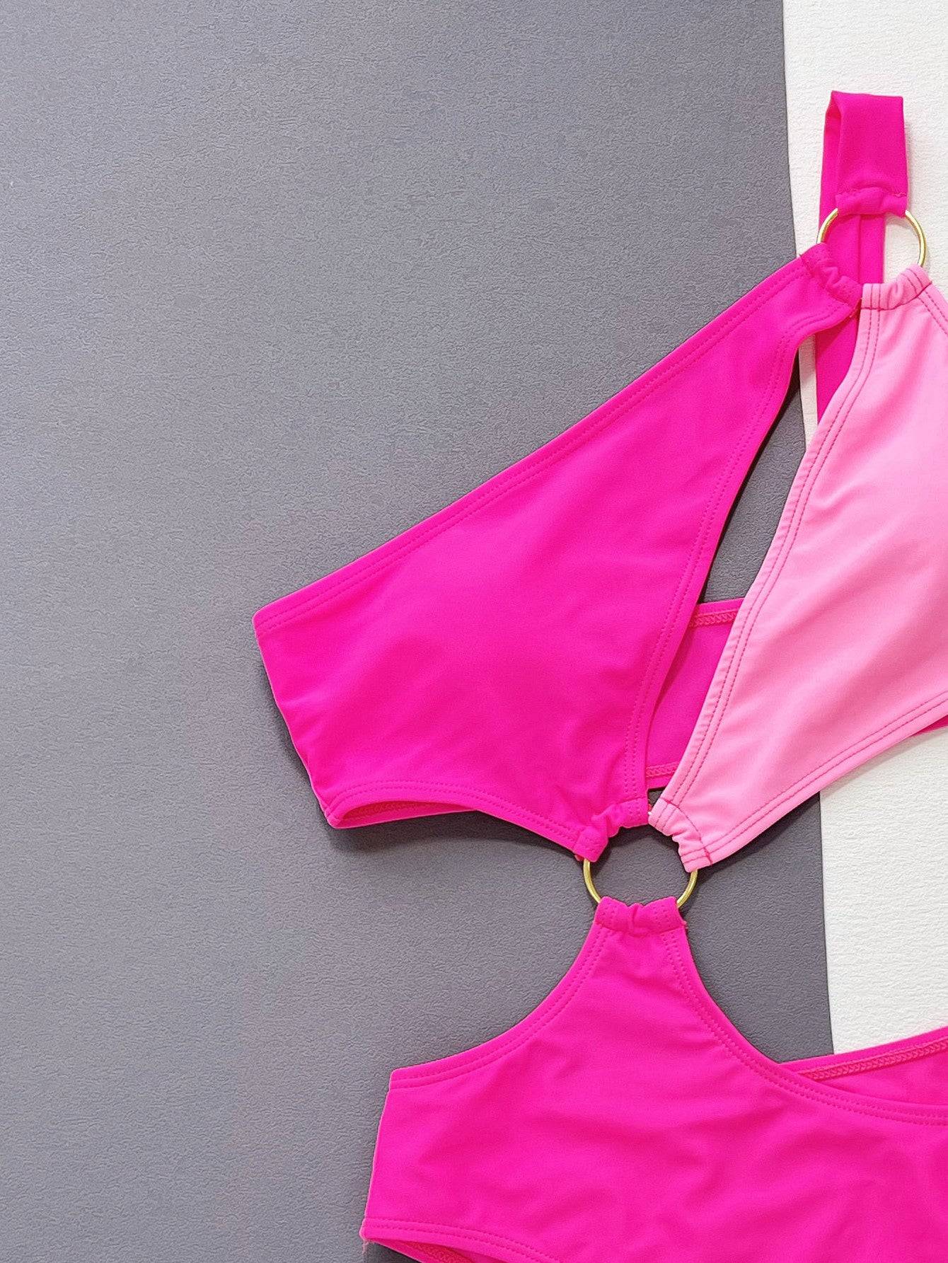 Close-up of pink one-shoulder cutout ring detail swimsuit