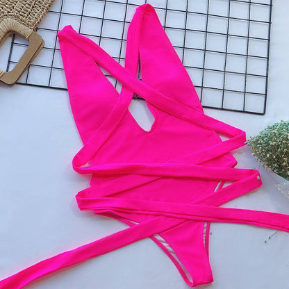 Flat lay of pink tied one-piece swimsuit