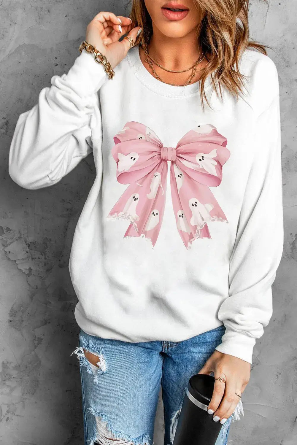 White sweatshirt with pink bow and ghost design