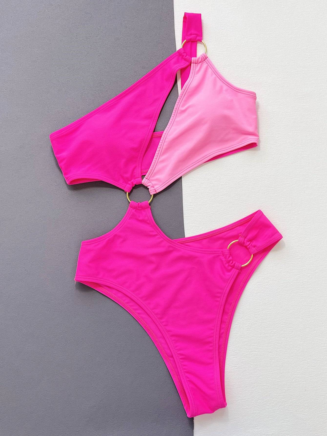 Flat lay of pink one-shoulder cutout ring detail swimsuit