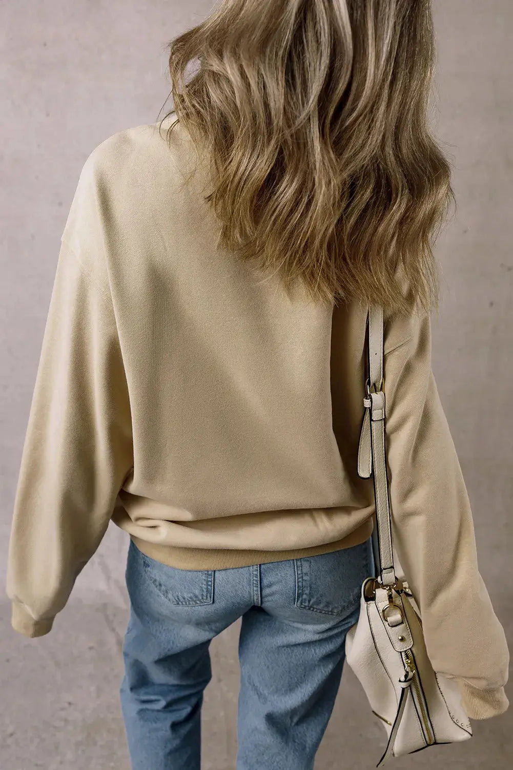 Back view of beige long sleeve sweatshirt