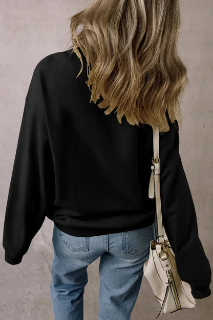 Back view of black sweatshirt with long sleeves