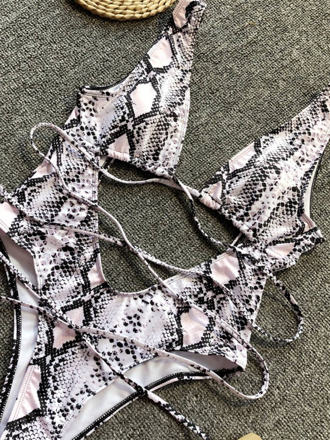 Close-up of snake print lace-up swimwear details