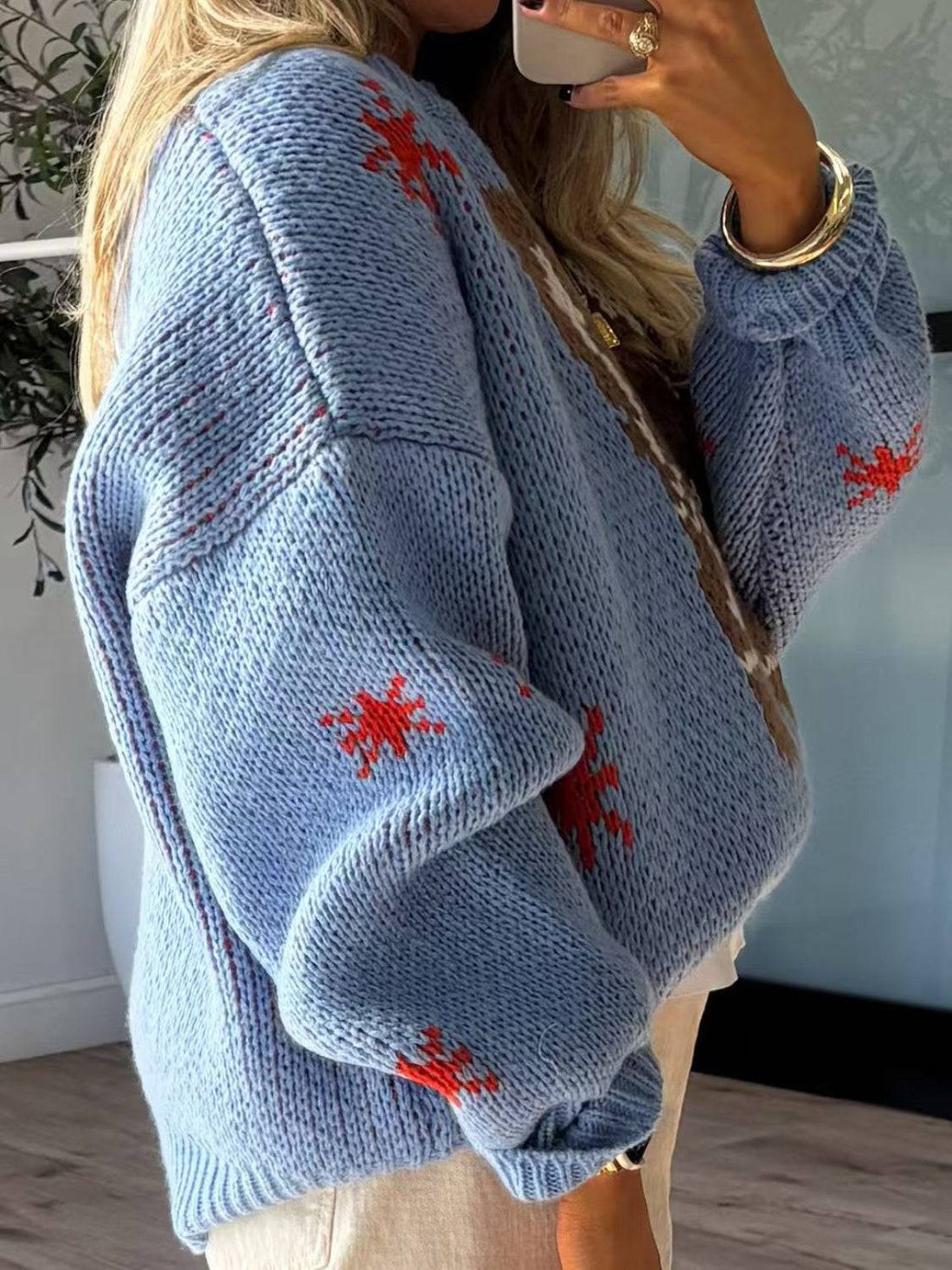 Side view of blue sweater with boot design