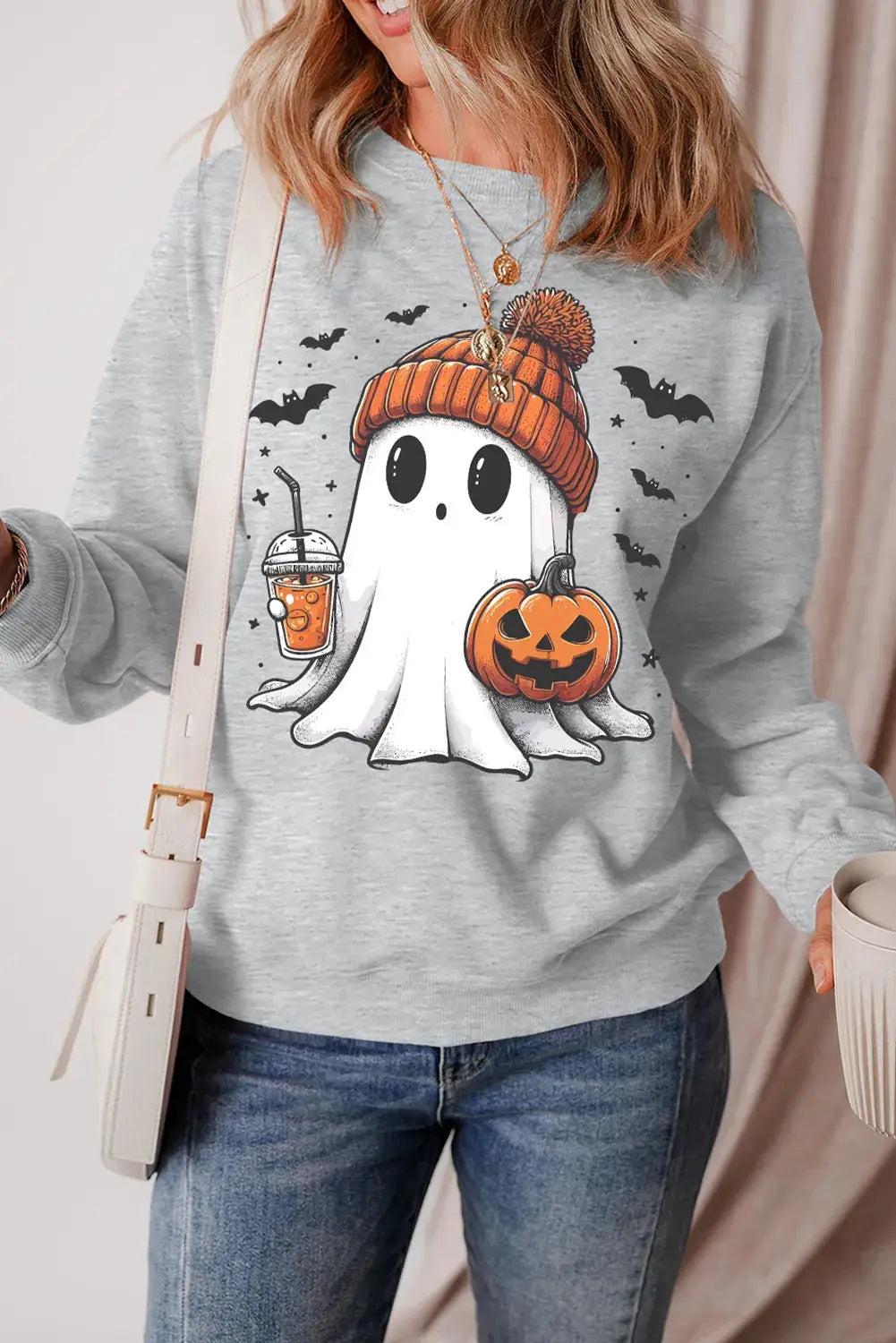 Ghost sweatshirt with pumpkin and drink design, front view