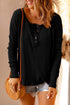 Black half button drop shoulder T-shirt with denim shorts.