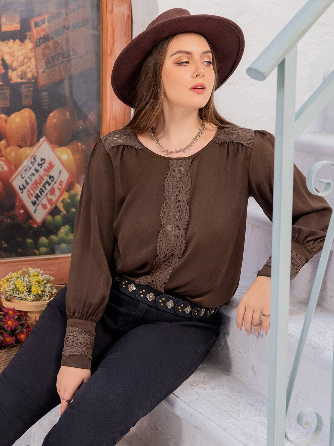 Plus size blouse with lace detail and round neck, front view.