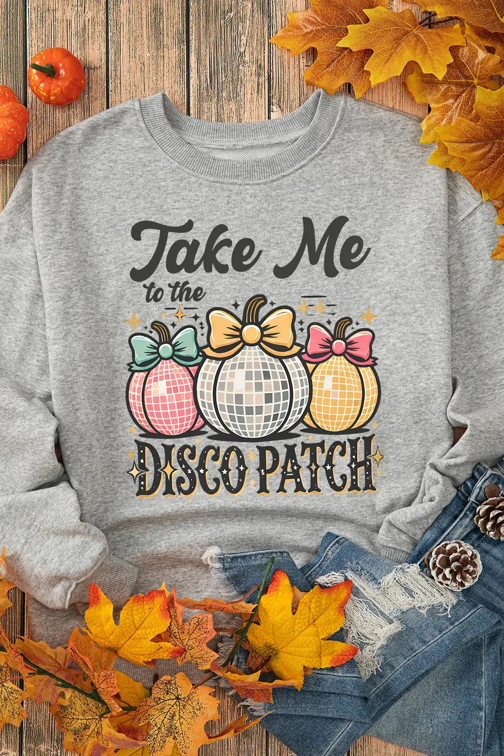 Sweatshirt with disco patch design surrounded by autumn leaves.