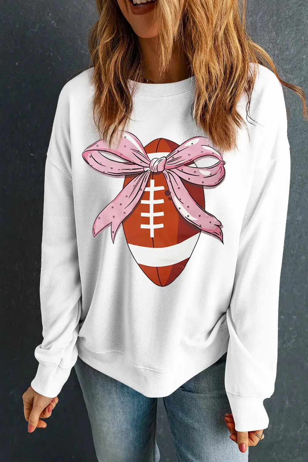 White sweatshirt with football and pink bow design