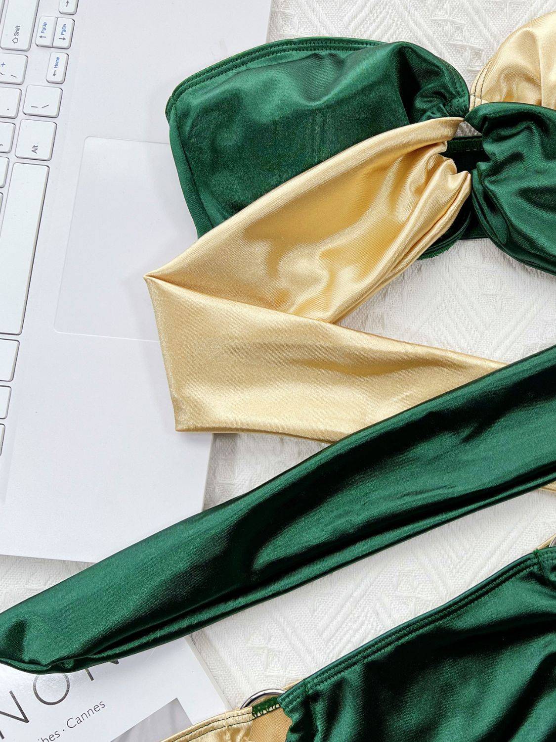 Close-up of green and gold bikini top with ring detail