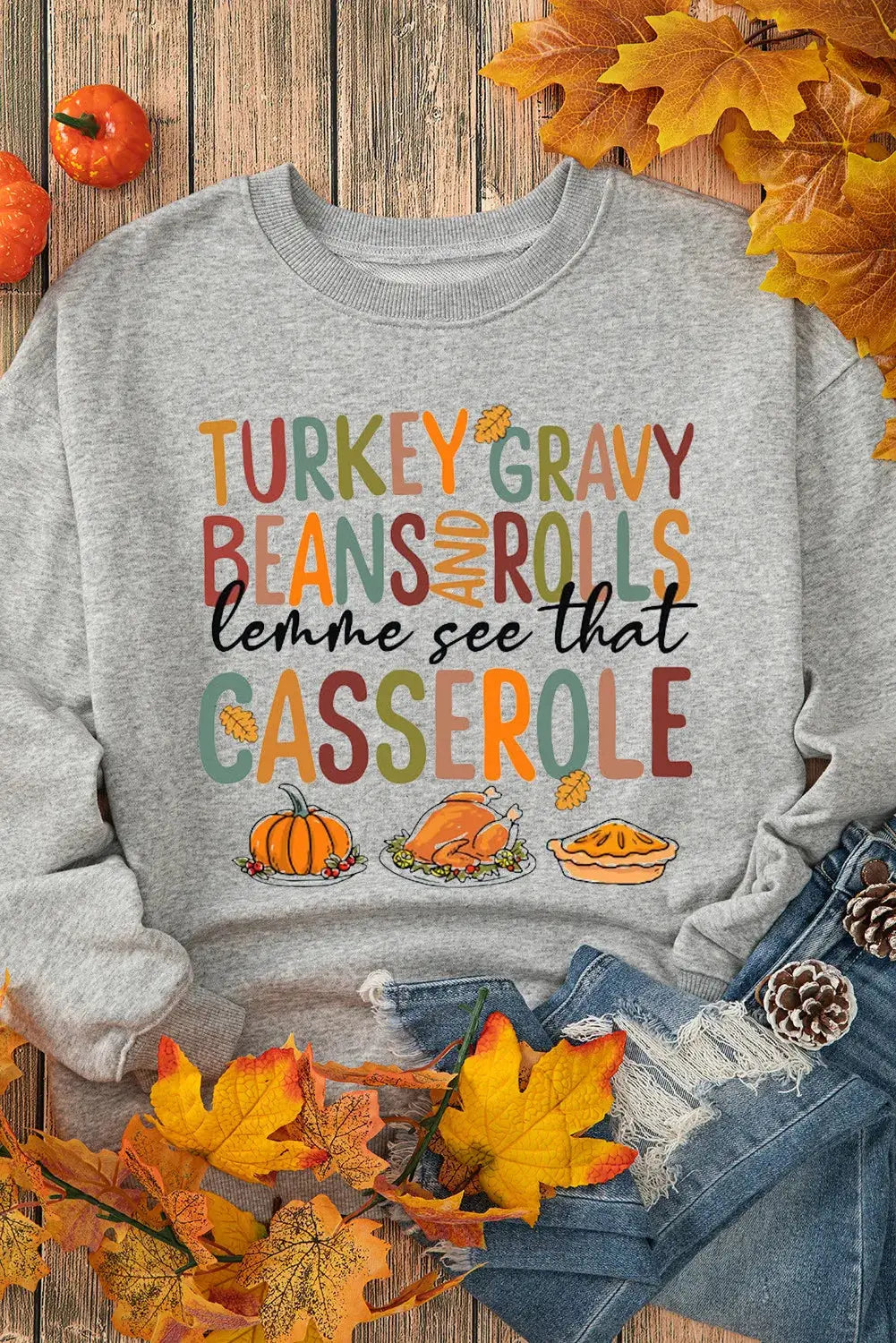 Sweatshirt with Thanksgiving graphics and autumn leaves.