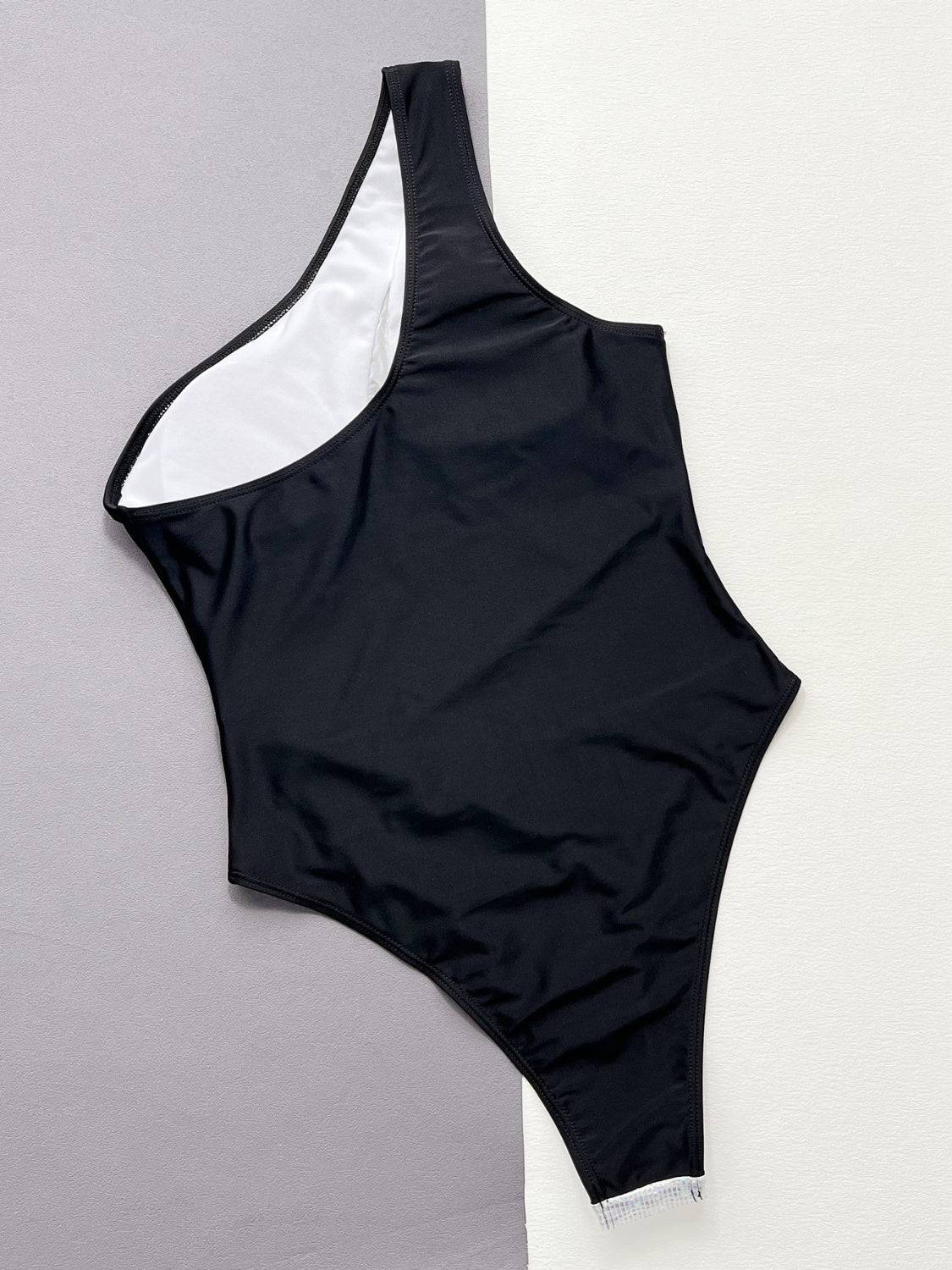 Black one-piece swimsuit flat lay