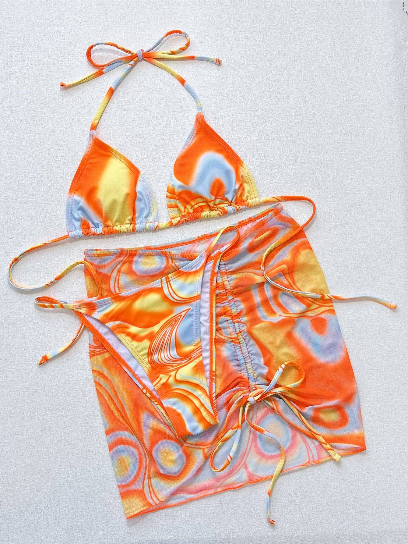 Three-piece multicolored bikini set laid flat.