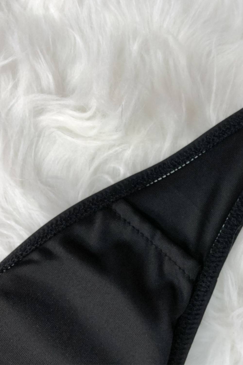 Edge stitching on black swimsuit fabric