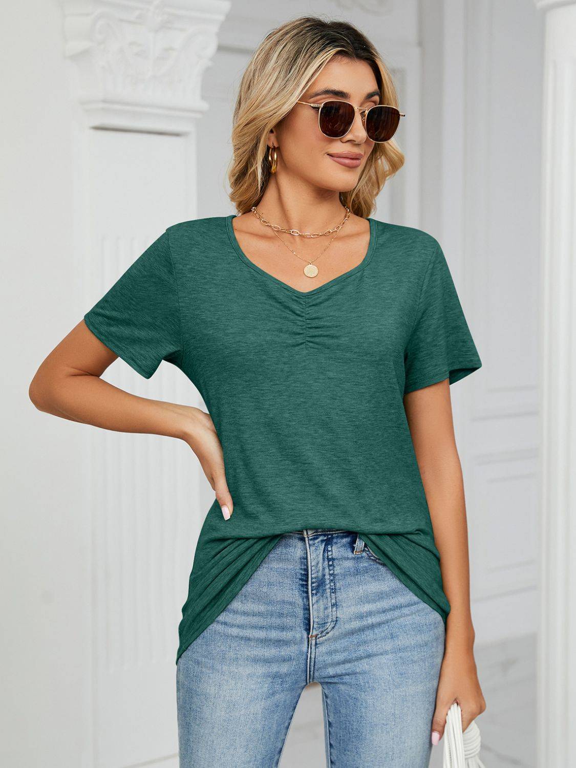 Green ruched V-neck T-shirt styled with sunglasses