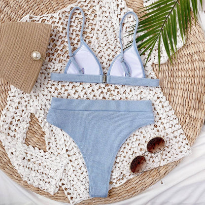 Light blue ribbed bikini set laid out with accessories