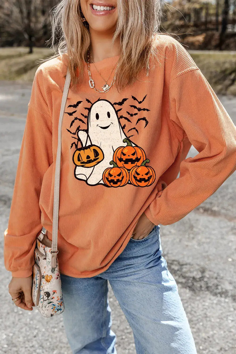 Halloween-themed sweatshirt with ghost and pumpkins