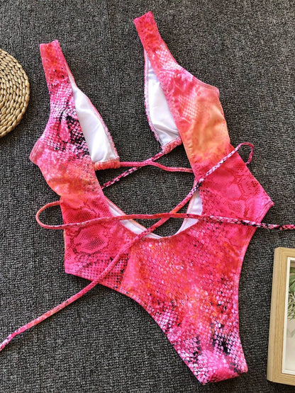 Flat lay of pink lace-up one-piece swimwear