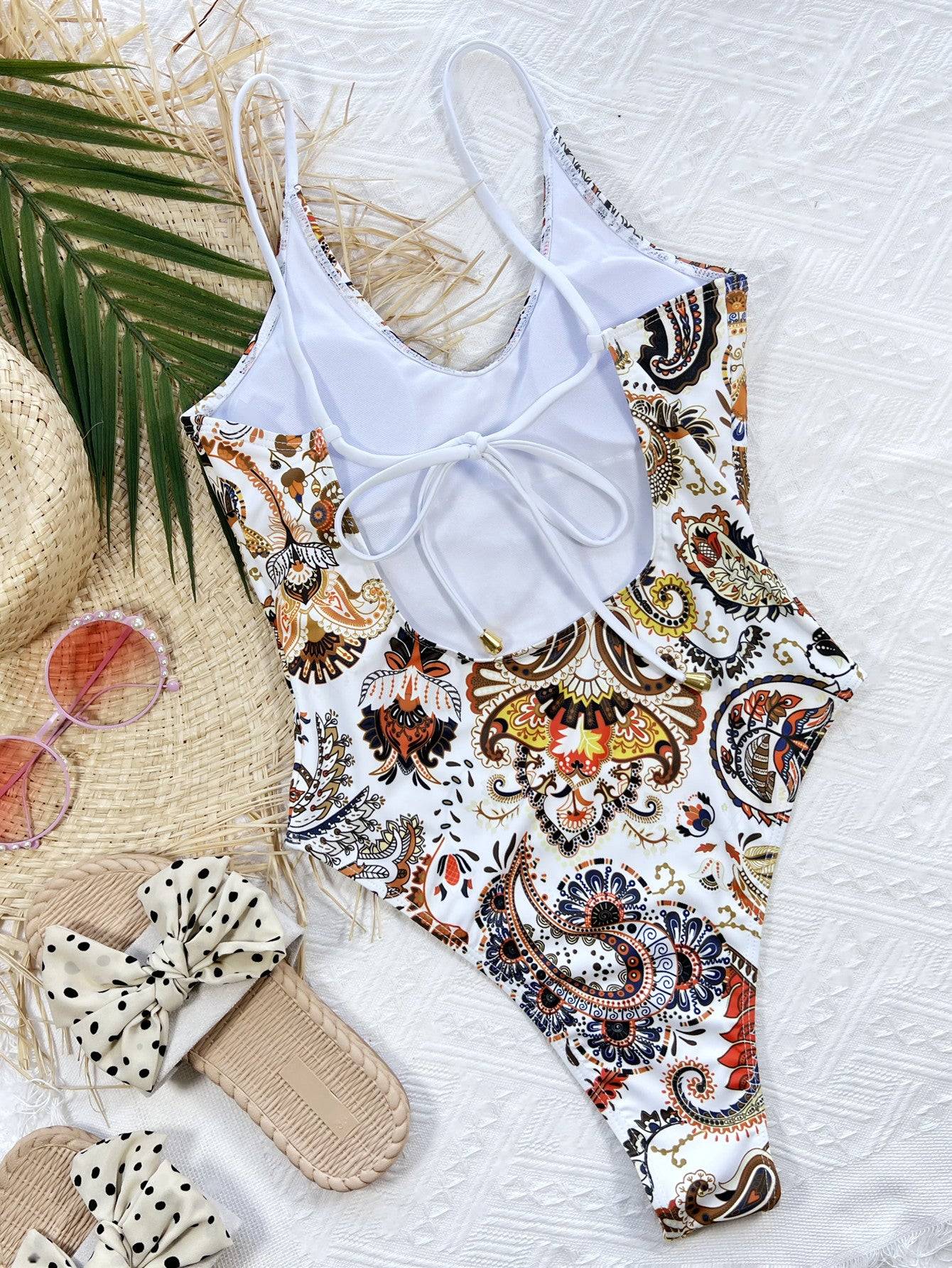 Back of printed one-piece swimsuit with accessories