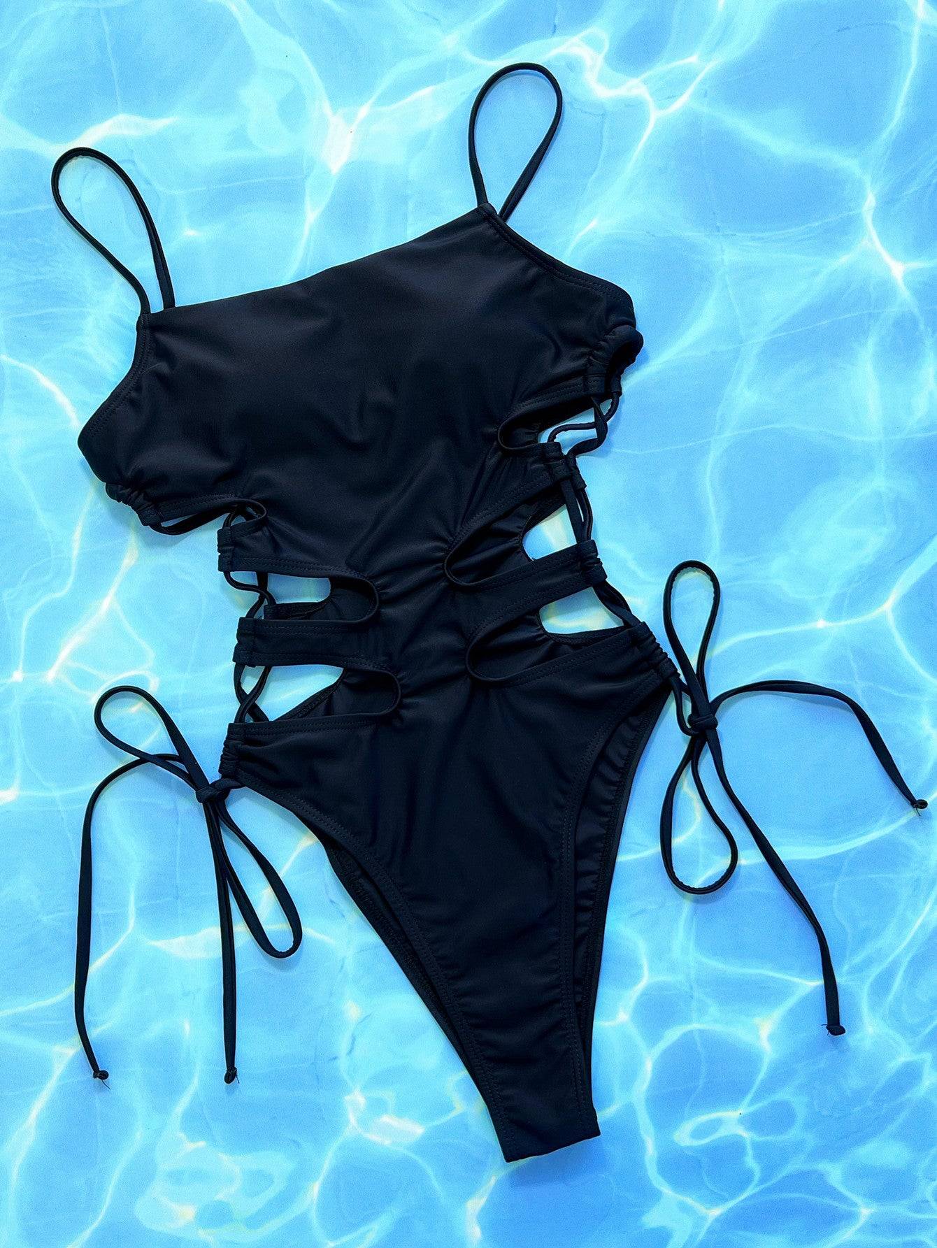 Black cutout lace-up one-piece swimsuit on blue background