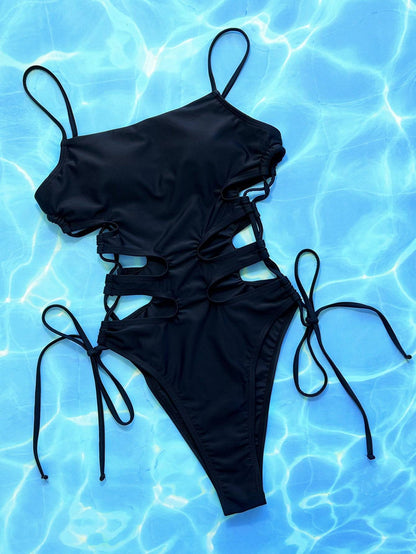 Black cutout lace-up one-piece swimsuit on blue background