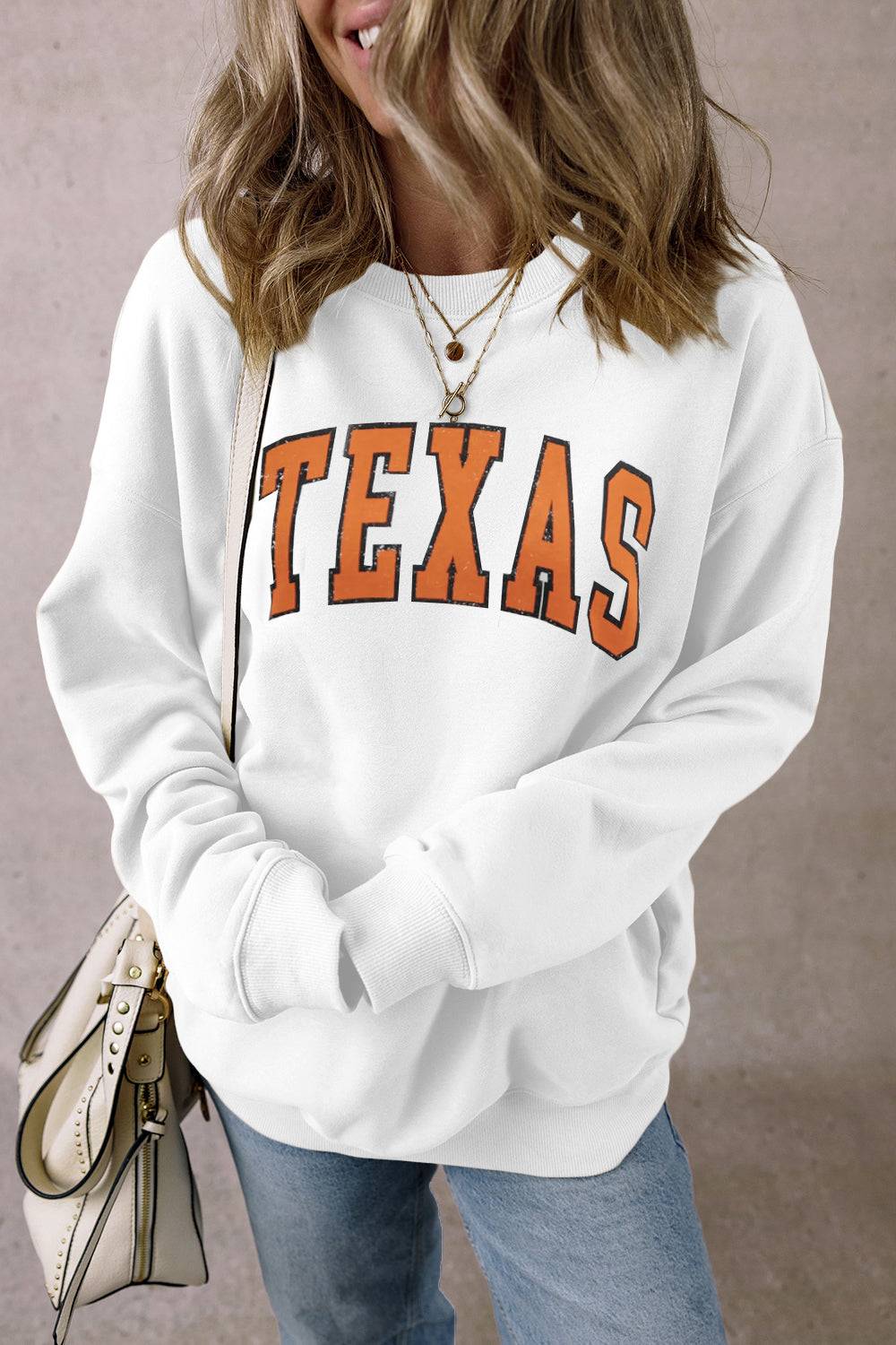 White TEXAS sweatshirt with round neck and dropped shoulders.