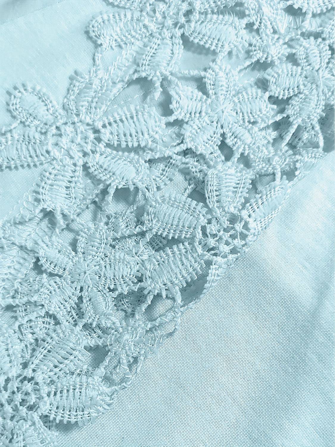 Close-up of lace details on light blue long sleeve t-shirt