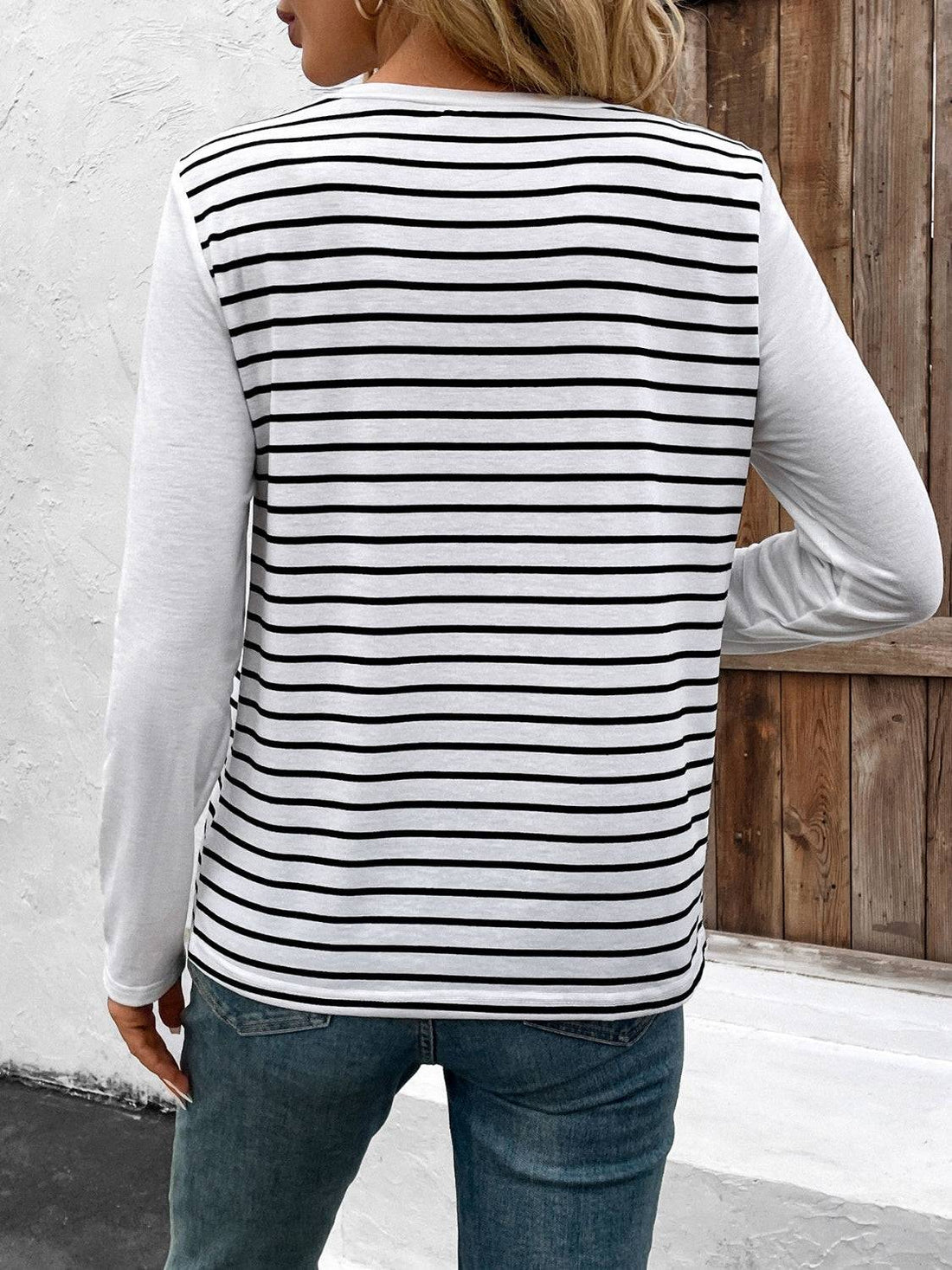 Back view of striped round neck long sleeve T-shirt.