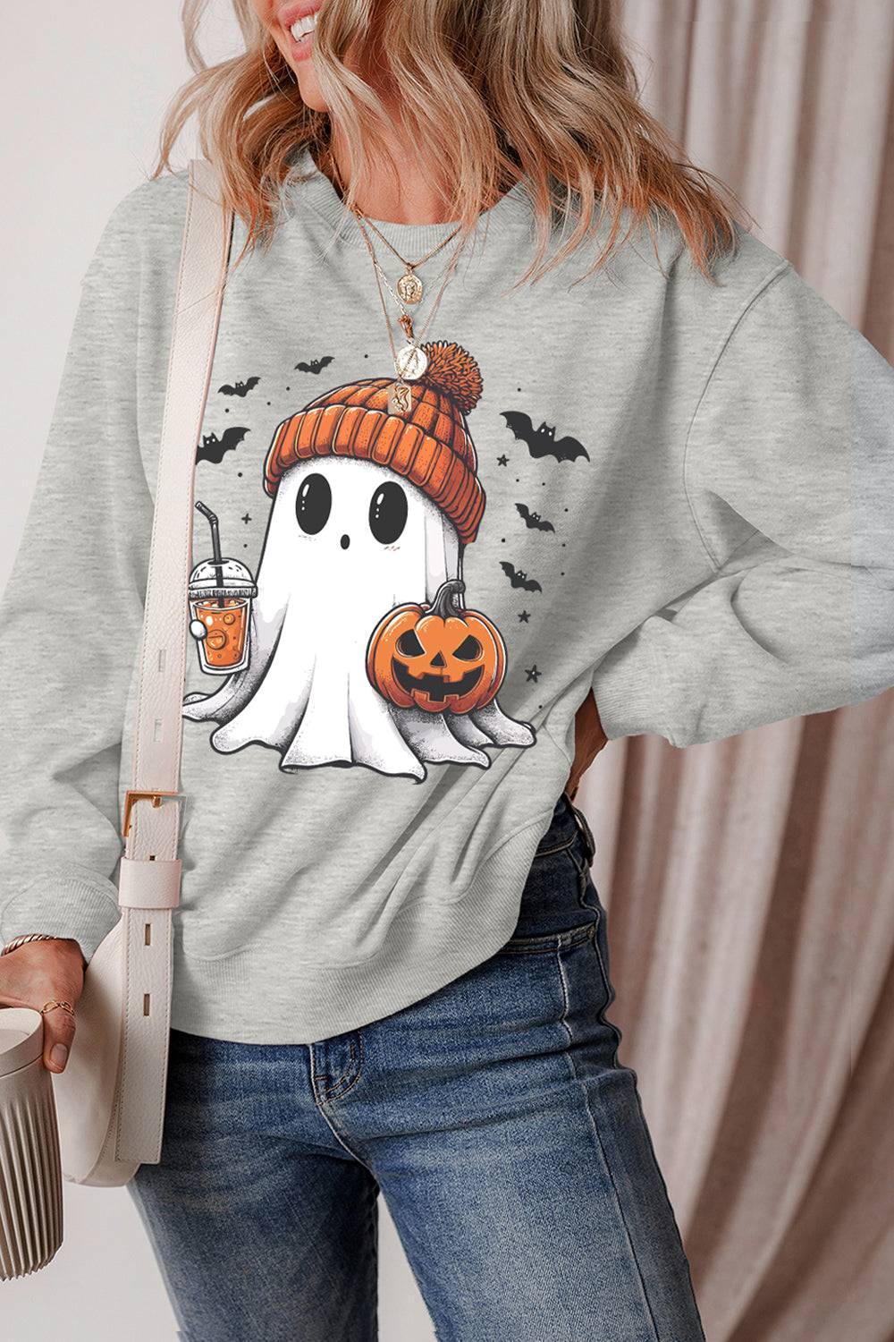 Ghost sweatshirt with pumpkin and drink design, side view