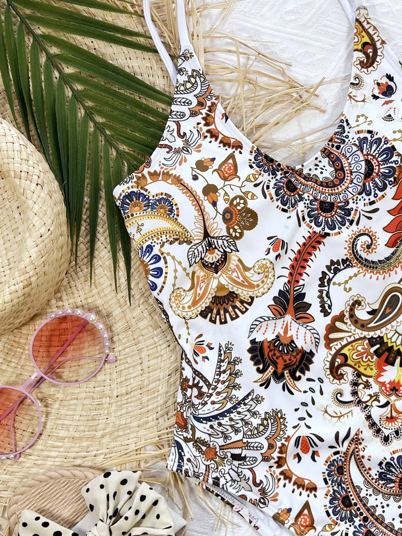 Close-up of printed one-piece swimsuit with accessories