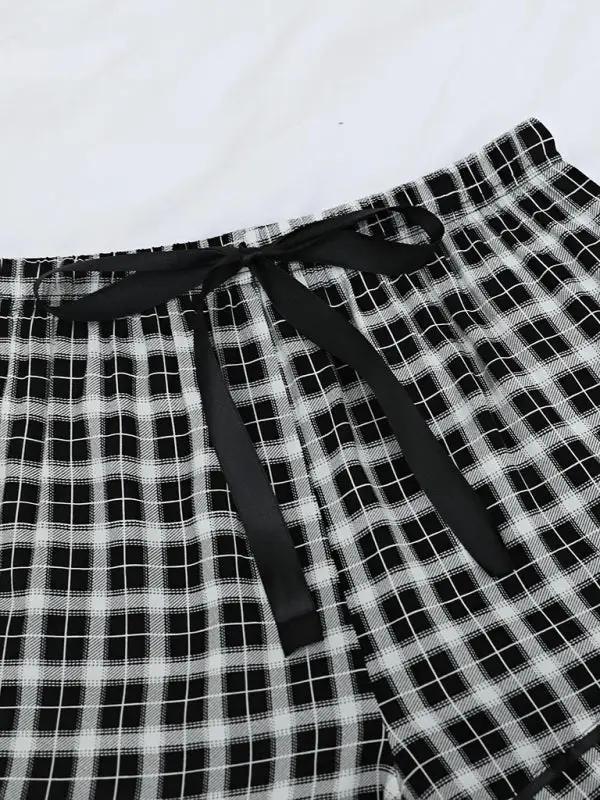 Close-up of plaid pajama pants with ribbon tie