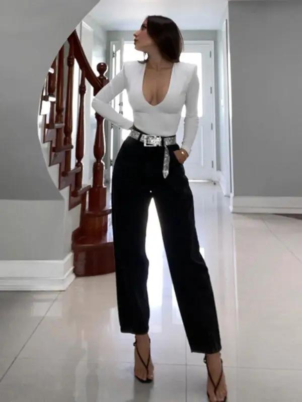 White deep V long sleeve bodysuit with black pants