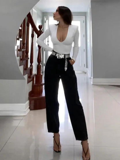 White deep V long sleeve bodysuit with black pants
