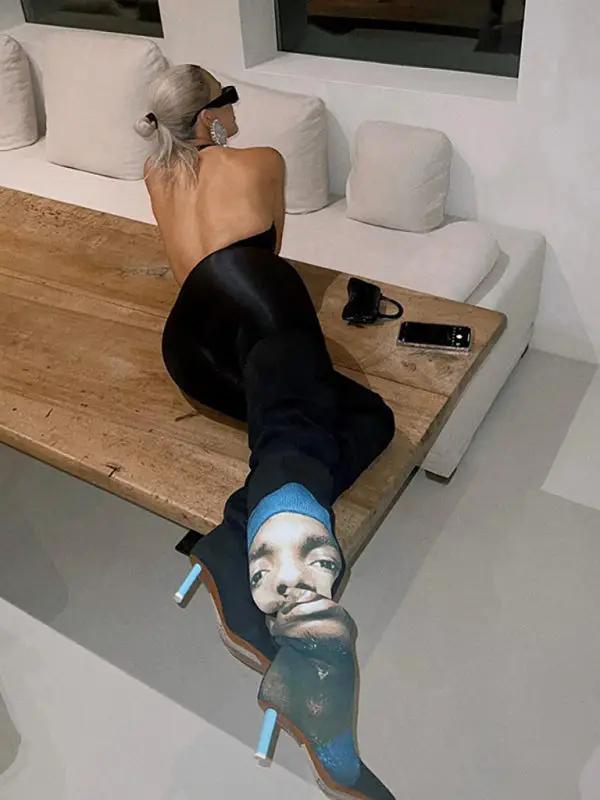 Back view of black jumpsuit, seated pose