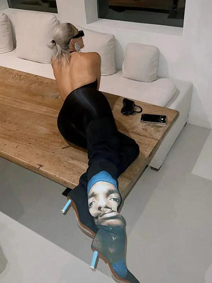 Back view of black jumpsuit, seated pose