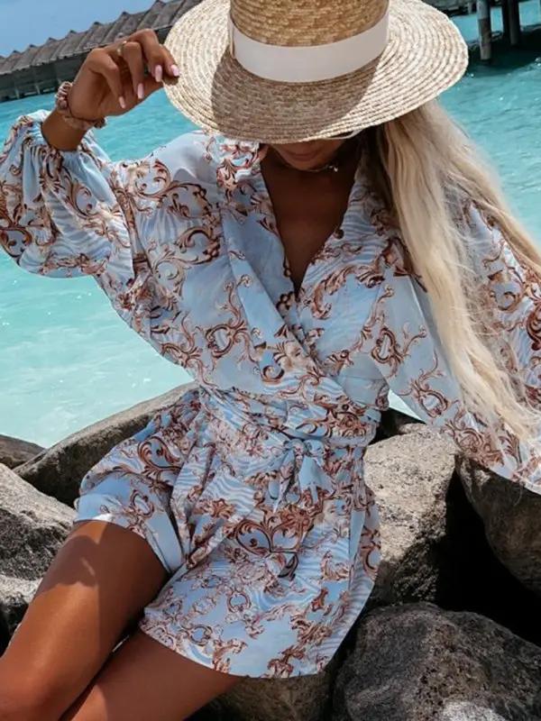 Walking on beach in blue floral jumpsuit