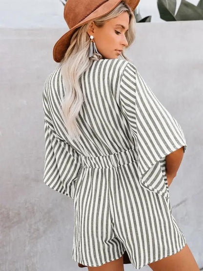 Back view of green striped jumpsuit with trumpet sleeves