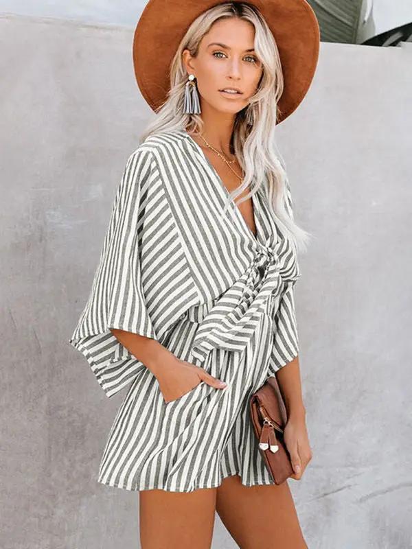 Green striped jumpsuit with deep V and trumpet sleeves
