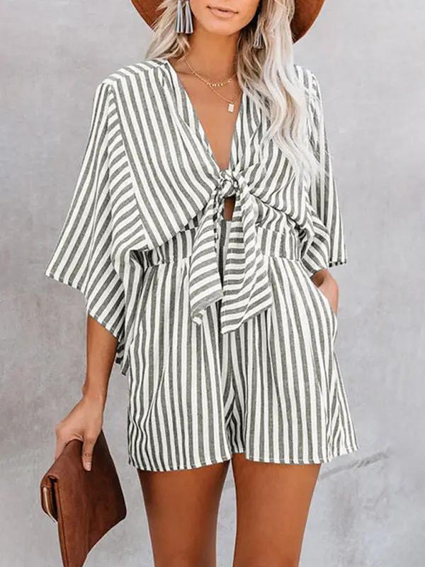 Green striped jumpsuit with deep V and trumpet sleeves