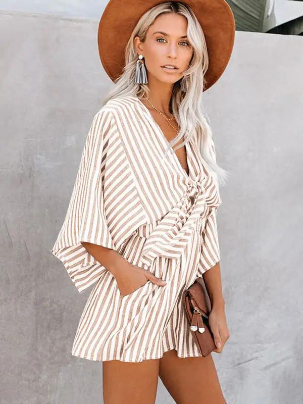 Brown striped jumpsuit with deep V and trumpet sleeves