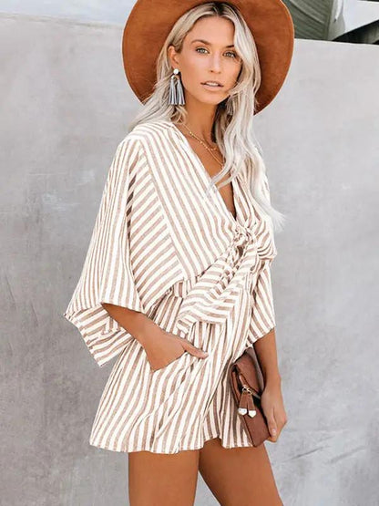 Brown striped jumpsuit with deep V and trumpet sleeves