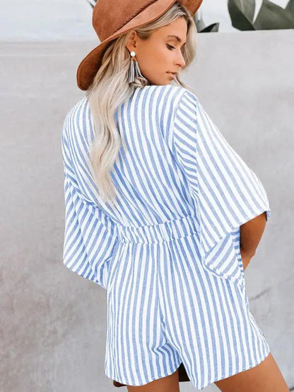 Back view of blue striped jumpsuit with trumpet sleeves