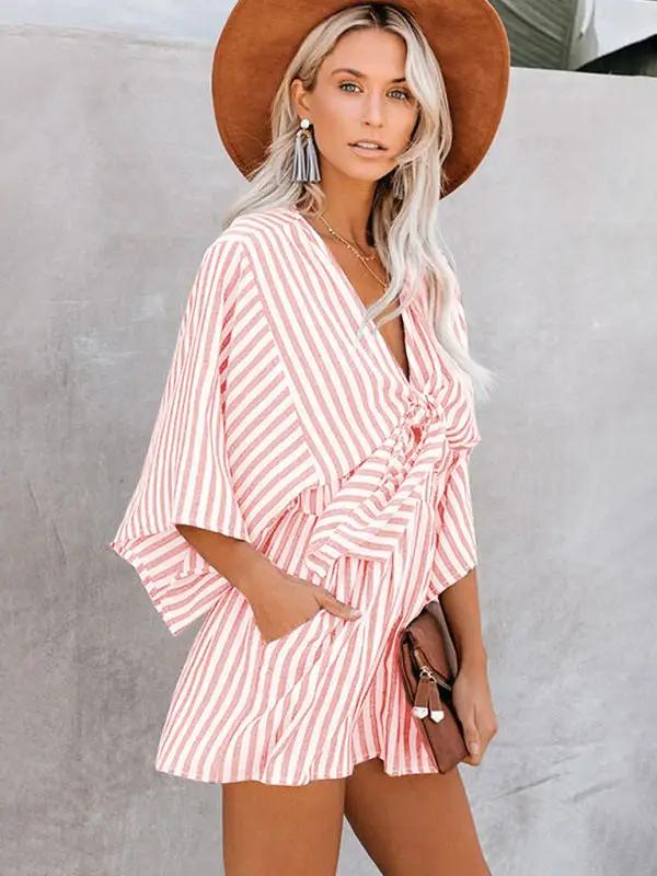 Pink striped jumpsuit with deep V and trumpet sleeves